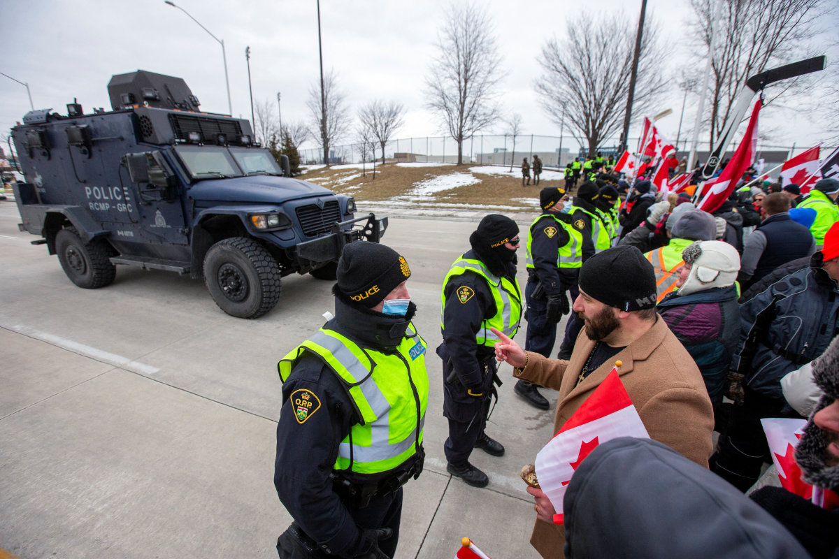Truckers pull out autos from key US-Canadian border bridge, protests swell elsewhere